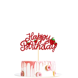 Red glitter Happy Birthday cake topper with strawberry accents on a pink frosted cake