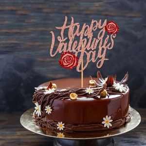 Pink glitter Happy Valentine's Day cake topper with red roses on a chocolate cake