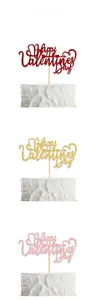 Detail of glitter Happy Valentine's Day cake toppers in red, gold and pink sparkling colors