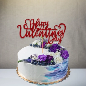 Red glitter Happy Valentine's Day cake topper decoration on a fresh floral cake