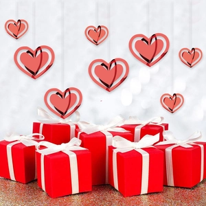 Red Valentine gift boxes with white bows and hanging double-layer heart ornaments