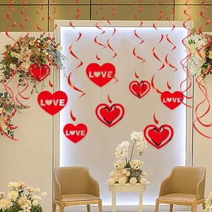 Red heart spiral swirls with LOVE tags and hollow heart cutouts for Valentine's Day party decor