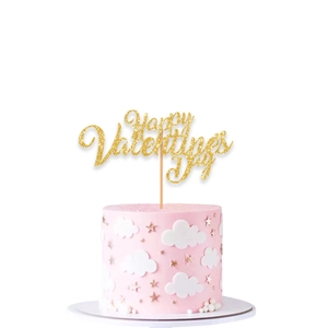 Close-up of golden glitter Happy Valentine's Day cake topper on pink decorated cake