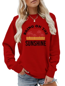 Close-up of Bring On The Sunshine graphic print on red long sleeve sweatshirt