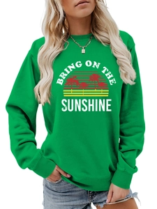 Detail of green crewneck sweatshirt with Bring On The Sunshine graphic and coconut tree