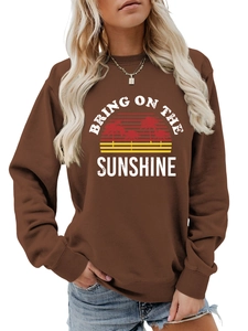 Detail of ribbed cuffs and sunshine graphic on brown crew neck sweatshirt