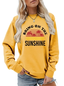 Close-up of Bring On The Sunshine graphic print on mustard yellow crewneck sweatshirt