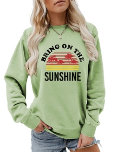 Close-up of Bring on the Sunshine print and ribbed cuffs on sage green sweatshirt