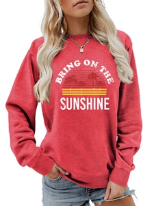 Detail of red crewneck sweatshirt featuring white Bring On The Sunshine graphic print