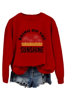 Close-up of the Bring On The Sunshine graphic on a red crewneck sweatshirt