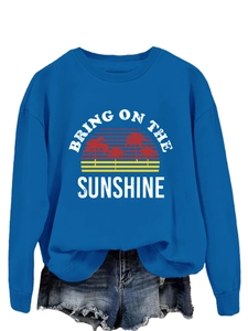Detail of blue crewneck sweatshirt with Bring On The Sunshine graphic and palm tree print