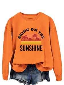 Detail of sun and palm tree print on orange cotton blend sweatshirt with retro text