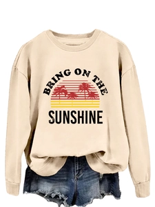 Detail of crewneck sweatshirt with Bring On The Sunshine print and sunset graphic