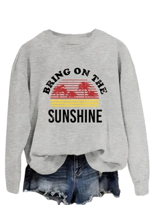 Detail of grey sweatshirt print with Bring On The Sunshine sunset and palm tree graphics