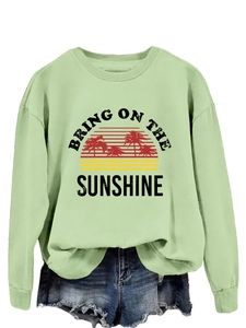 Detail of the vintage sun and palm tree graphic print on this casual green sweatshirt