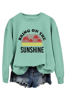 Detail of mint green sweatshirt with Bring On The Sunshine vintage palm tree print