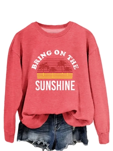 Close-up of coral pink sweatshirt featuring Bring On The Sunshine graphic print