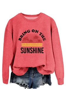 Detail of coral pink sweatshirt with Bring On The Sunshine print and frayed denim shorts
