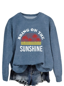 Close-up of Bring on the Sunshine print on blue loose sweatshirt with palm tree graphics