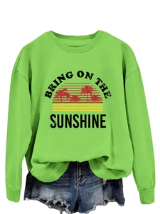 Detail of the sun and palm tree print on this green Bring On The Sunshine sweatshirt