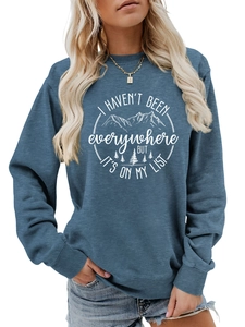 Detail of navy sweatshirt featuring white mountain forest print and inspirational quote