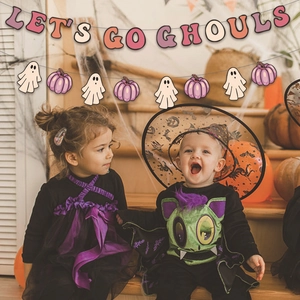 Pink Halloween decoration set with Let's Go Ghouls banner and spooky party ornaments