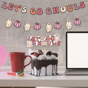 Pink Halloween party set with Let’s Go Ghouls banner and cute ghost cake toppers