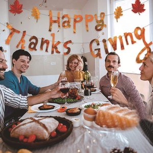 Happy Thanksgiving banner with maple leaf patterns for festive indoor party decoration