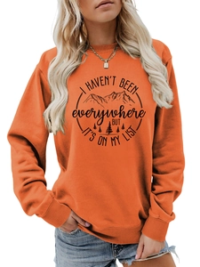 Close-up of orange sweatshirt with mountain print and I haven't been everywhere text