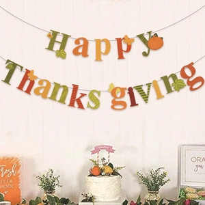 Happy Thanksgiving banner with pumpkin and maple leaf elements on white wood background