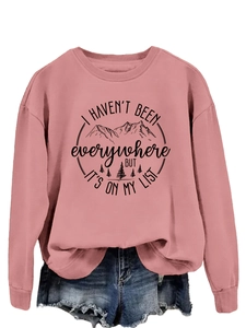Detail of the rose pink sweatshirt featuring a mountain graphic and inspirational quote