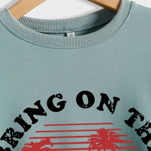Retro sage green crewneck sweatshirt with 'Bring on the Sunshine' palm print