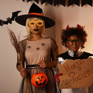 Halloween party costume set with pumpkin glasses, witch hat, and spooky decor accessories