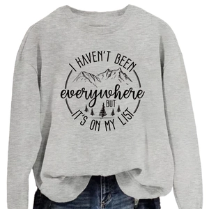 Light gray crewneck sweatshirt with mountain graphics and I Haven't Been Everywhere quote