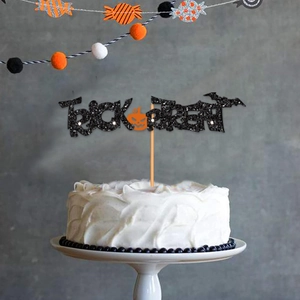 Glittery black Trick or Treat cake topper with orange pumpkin for Halloween party