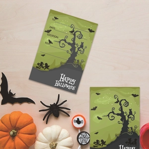 Detail view of Halloween invitation cards with bats and trees on a wooden background