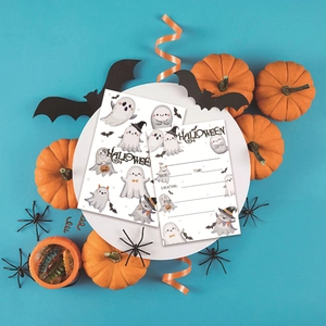 Close-up of Halloween ghost invitations with fill-in-the-blank text on a blue background