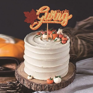 Glittery Thanksgiving cake topper with maple leaf and Thanks Giving script