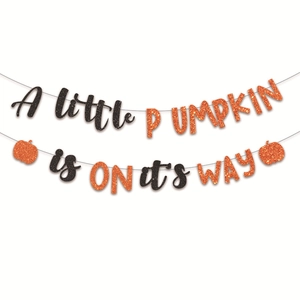 Glittery 'A little PUMPKIN is on its way' banner with orange pumpkins for baby shower