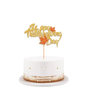 Close-up of golden glitter Happy Thanksgiving Day cake topper with orange maple leaves