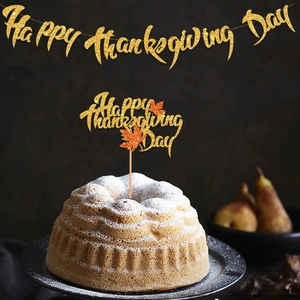 Glittery gold Happy Thanksgiving banner and maple leaf cake topper for autumn party decor