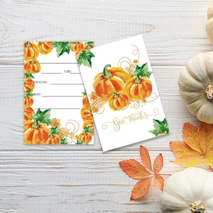 Close-up of Thanksgiving pumpkin cards on white wood with RSVP details and autumn leaves