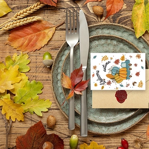 Flat lay of Welcome Autumn card with pumpkin illustrations on a ceramic plate