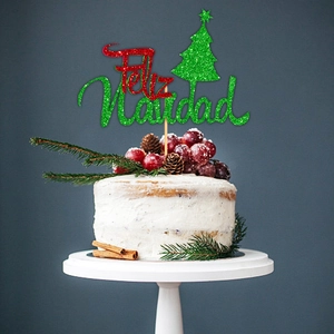 Sparkly Feliz Navidad cake topper with green Christmas tree on white festive cake