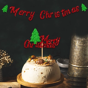 Close-up of red glitter Merry Christmas cake topper and banner set with tree decor