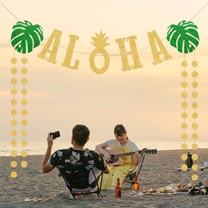 Tropical Hawaii party set with gold glitter ALOHA banner, monstera leaves, and round dots