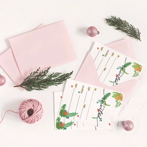 Tropical Hawaiian party invitation set with pink envelope and floral leaf motifs