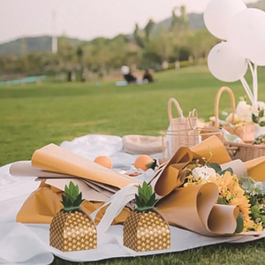 Creative pineapple shaped wedding favor boxes with green leaf design and yellow pattern
