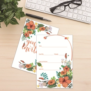 European floral wedding invitation cards with hibiscus patterns on a wooden desk