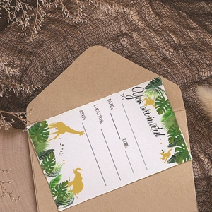 Jungle theme birthday party invitation cards with gold animal silhouettes and green leaves